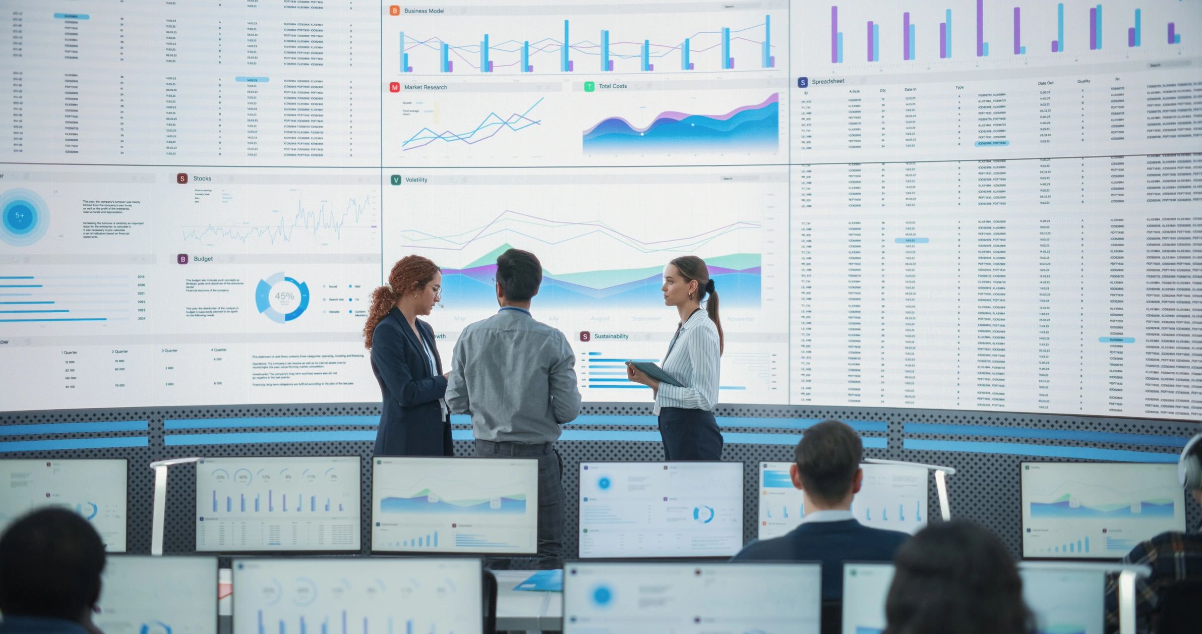 Team reviewing performance dashboards and reports on a large screen