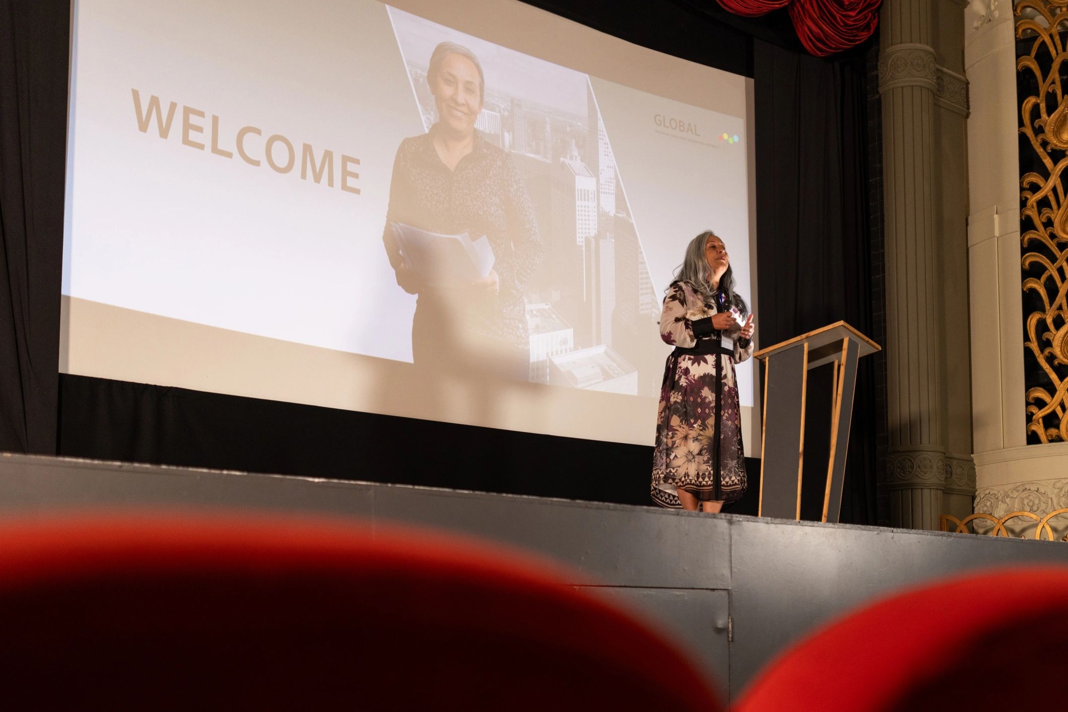 Keynote speaker presenting on stage at a business conference